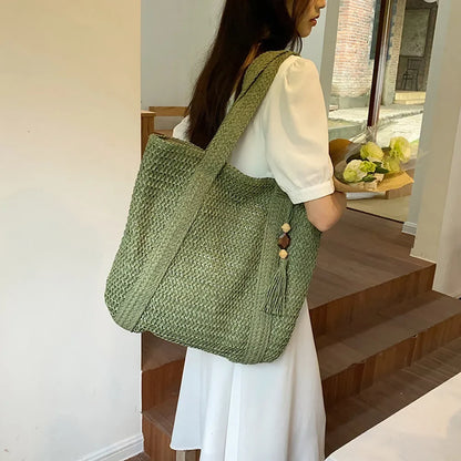 Beige boho straw beach tote bag with woven handles