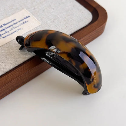 Close-up detail of the acetate claw clip finish