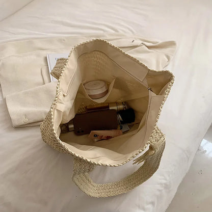 Straw tote bag with zip-top closure and boho bead tassel detail